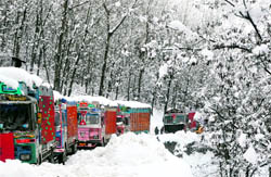 Trucks stranded on the Srinagar-Jammu National Highway near the Jawahar Tunnal on Friday as the road remained closed due to heavy snowfall
