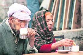 A Kashmiri couple having tea at the general bus stand in Jammu