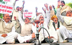 Gujjar community members hold placards during a protest at Parliament Street in New Delhi on Friday