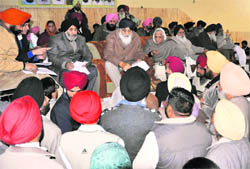 Punjab Chief Minister Parkash Singh Badal listens to grievances of villagers during a Sangat Darshan held at Morinda