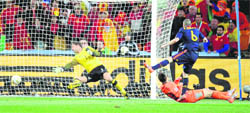 Spains Andres Iniesta (R) scores the World Cup-winning goal against the Netherlands in South Africa.