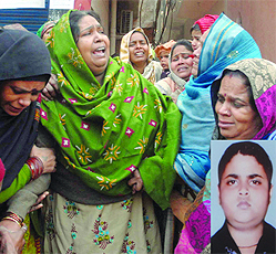 Family members of the victim, Vikas (inset), mourn his death. 