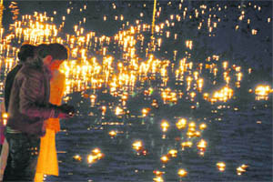 Devotees float lit earthen lamps in Neel Dhara as offering on New Years Eve in Haridwar on Friday.