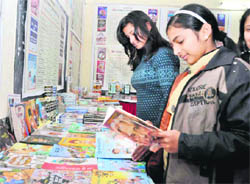 Students have a look at books on display at a book fair at Bannu School in Dehradun on Saturday.
