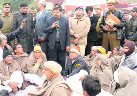 DC Vijay Singh Dahiya talks to the agitating farmers in Fatehabad on Saturday. A Tribune photograph