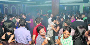 Youngsters enjoy at a dance party to mark the New Years eve in Gurgaon on Friday.