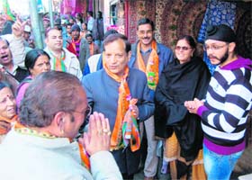 Industry Minister Kishan Kapoor (centre) campaigns for BJP nominees Virender Parmar and Onkar Nehria in Dharamsala
