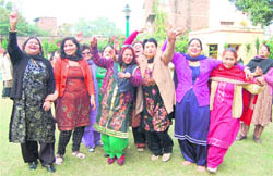 Women dance during a function to celebrate New Year at the Janana Park in Jammu