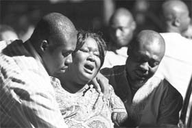 A woman mourns the death of her husband in a bomb explosion near military barracks in Abuja