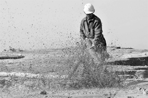 A worker waters the site of a rare earth metals at a Chinese mine. China will not issue more rare earth export quotas for foreign companies next year, and the first batch for 2011 totalling 14,446 tonnes included those for foreign firms, according to the Commerce Ministry.