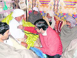 A doctor from the general hospital examines an ailing farmer, Ram Kumar, at the dharna site in Fatehabad on Sunday.