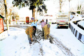 MC officials in the process of clearing snow from a road in Dalhousie on Sunday
