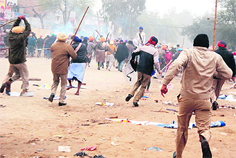 Policemen lathicharge Sikh hardliners to disperse them following tension with followers of Dera Sacha Sauda at Bhikhi town in Mansa district on Sunday.