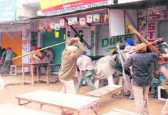 Policemen lathicharge Sikh hardliners to disperse them following tension with followers of Dera Sacha Sauda at Bhikhi town in Mansa district on Sunday.