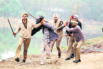 Policemen lathicharge Sikh hardliners to disperse them following tension with followers of Dera Sacha Sauda at Bhikhi town in Mansa district on Sunday.