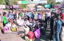 Safai workers stage a protest at the busy Bharat Nagar Chowk by blocking traffic to press for their demands in Ludhiana.