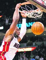 Miami Heat's Dwyane Wade dunks against the Golden State Warriors during fourth quarter NBA basketball action in Miami on Sunday. 