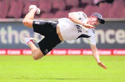 England's Paul Collingwood dives through the air while attempting a catch at training ahead of the fifth Ashes Test in Sydney on Sunday