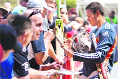 Australian batsman Usman Khawaja signs autographs during the team's final training session at the Sydney Cricket Ground (SCG) on Sunday. Pakistan-born Khawaja will become the first Muslim to play Test cricket for his adopted country, when he makes his debut in the fifth Test