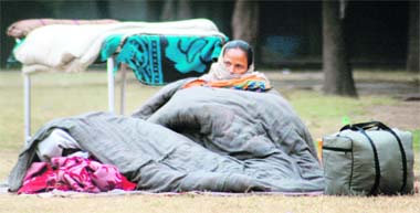 An attendant sits in the open in the chilly weather in front of the emergency at the PGI in Chandigarh on Monday.