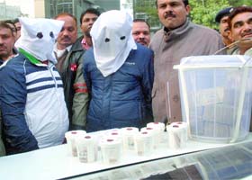 The accused and the booty seized in New Delhi