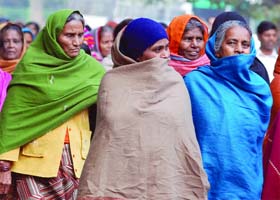 Braving the cold: Women cover themselves with shawls in New Delhi
