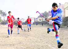 Players in action at a match of the District Hockey League Championship in Dehradun on Monday