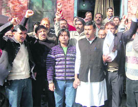 Members the Congress Labour Cell protest in Dehradun on Monday.