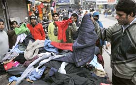 With the temperature hitting new lows, people purchase woollen clothes from a roadside vendor in Karnal. 