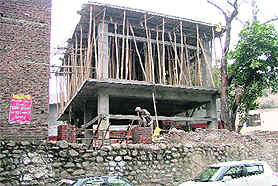 Gate of a temple being constructed along a compound wall of the MC head office in Ludhiana on Monday. 