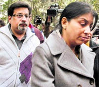 Rajesh Talwar and Nupur Talwar arrive at a court for a hearing in connection with CBI's closure report in the murder case of their teenage daughter Aarushi, in Ghaziabad on Monday
