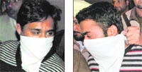 Two of the suspects in police custody
