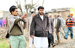 A colony resident raises an issue with District Planning Board chairman NK Sharma in Mohali on Tuesday
