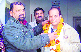 Pushpesh Tripathi, UKD legislator, being garlanded by party President Trivendra Singh Panwar on being elected leader of the legislature party in Dehradun on Tuesday.