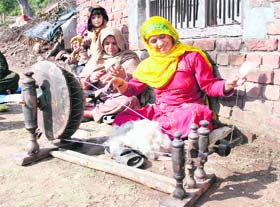 Women spin wool on a charkha in Nagrota village in Jammu.
