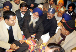 Ferozepur Deputy Commissioner KK Yadav (left) talks to BJP MLA Surjit Jiyani and Charan Singh, circle president, SAD (B), at the Clock Tower in Fazilka on Wednesday, where both leaders went on hunger strike.