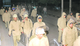Policemen in riot gears rush to the spot of violence.
