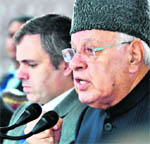 National Conference president and Union Minister for New and Renewable Energy Farooq Abdullah and Chief Minister Omar Abdullah address mediapersons in Jammu on Wednesday