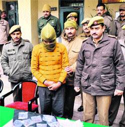 A thief along with stolen goods in police custody in Jammu on Wednesday