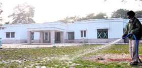 A worker waters the lawn at 07, Moti Lal Nehru Marg (Delhi)  the soon-to-be address of Ambala MP Kumari Selja