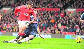 Manchester United's Mexican forward Javier Hernandez (L) scores the opening goal against Stoke City at Old Trafford in Manchester