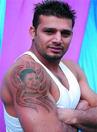 MEMORIES FADE, PICTURES DON'T: Bittu Dugal, an international kabaddi player, shows the tattoo of his friend Sarovar Dugals face that he had got engraved on his right arm, at the DAV College in Bathinda