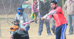 A player hits the ball during a softball match at PEC grounds in Chandigarh on Thursday.