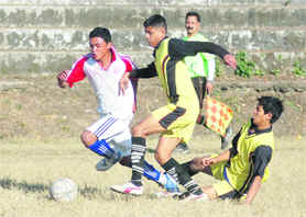 A match of the Great Vivekanand Memorial Football Tournament being played at the Pavillion Grounds in Dehradun on Thursday. A Tribune photograph