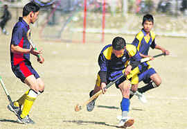 Hockey and (right) handball matches in progress at the Panchayat Sports Meet in Dehradun on Thursday.