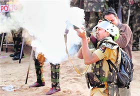 Police fires tear gas shells to disperse pro-Telangana students.