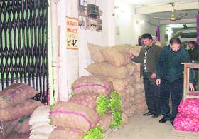 Income Tax officials check vegetables stored in one of the shops of a wholesaler at Salem Tabri