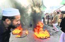 Supporters of the PPP burn tyres and raise slogans during a protest to condemn the killing of Salman Taseer, Governor of Punjab, in Peshawar, on Thursday. 