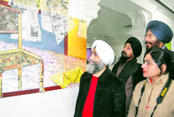 People take a look at an artifact at the Art Gallery in Amritsar
