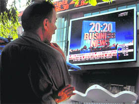 An investor is shocked as he looks at stock prices at a screen outside the Bombay Stock Exchange building in Mumbai on Friday. The Sensex dipped 493 points to end below 20,000 points on concerns that RBI may hike rates to tame inflation.